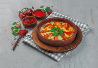 tomato roasted in cheese on gray background