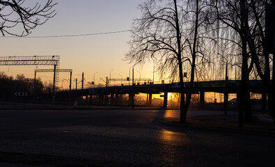 the silhouette of the bridge against the background of the rising sun