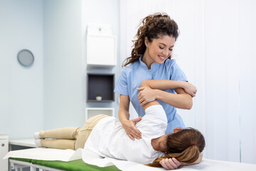 Physiotherapist treatment patient. Holding patient's hand, shoulder joint treatment. Physical...