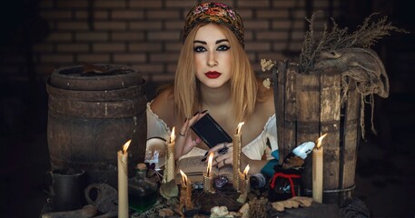 Gypsy woman with a Tarot cards, other witch stuff, concept of occultism and fate prediction 