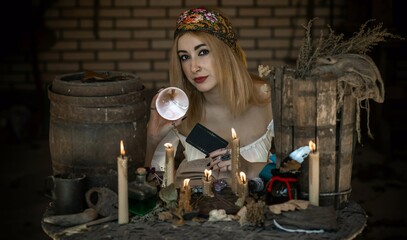 Gypsy woman with a Tarot cards, other witch stuff, concept of occultism and fate prediction 