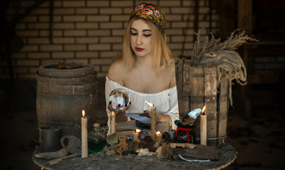 Gypsy woman with a Tarot cards, other witch stuff, concept of occultism and fate prediction 