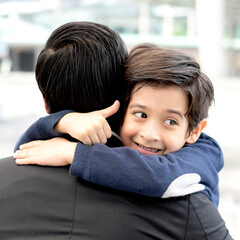 Happy little boy hugging his father - son and dad happiness family concept