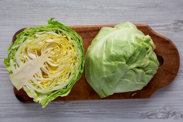 Raw Organic Cabbage on a Rustic Wooden Board, top view. Flat lay, overhead, from above.