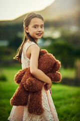 Teddy and I are going on an adventure. Portrait of a cute little girl playing with her teddybear outside.