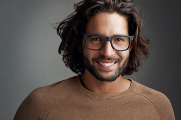 Frames that make a clear statement. Studio shot of a handsome young man wearing glasses against a...