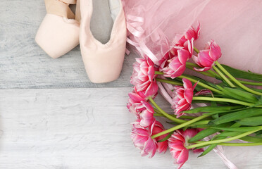 pointe shoes, tutu and bouquet of flowers in ballet,