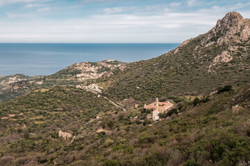 Fototapeta na wymiar Convent outside the hilltop village of Corbara in the Balagne region of Corsica with Mediterranean sea in the distance