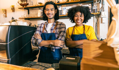 Young  couple asian man and african woman manager in restaurant with digital tablet or notebookWoman coffee shop owner with face mask hold open sign .Small business concept.