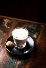 Coffee with milk on rustic wooden background. Soft focus. Close up. Copy space.