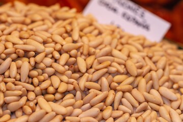 Bulk peeled pine nuts ready for sale at the Boqueria market in Barcelona (Spain), selective approach.