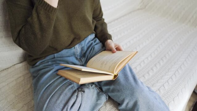 A girl is reading a book closeup