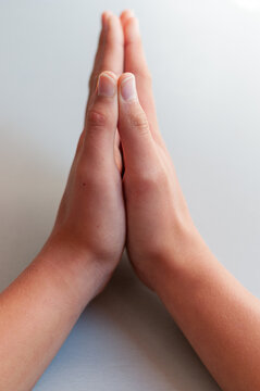 praying hands on a light grey background , concept of faith and belief .