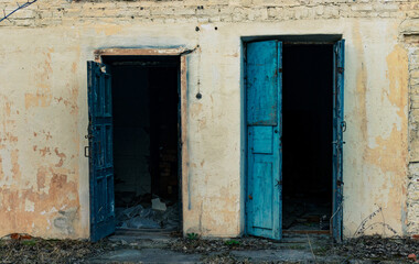 two open blue doors in an old abandoned building