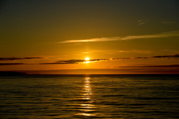 Beautiful sunset viewed from a cruise ship sailing round Alaska, glorious in its golden colours.