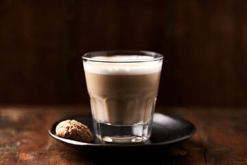 Coffee with milk on dark wooden background. Soft focus. Close up. Copy space.	