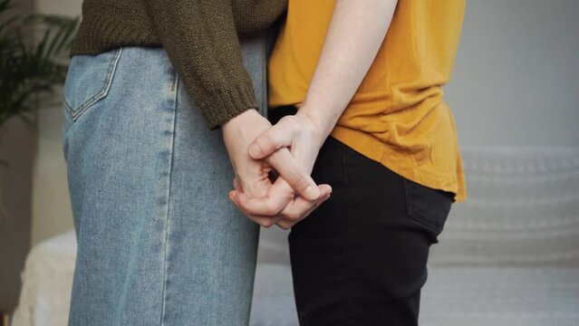 Two girls hold hands