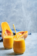 Pumpkin smoothie in glass. Homemade pumpkin smoothie served in glass on table. Pumpkin smoothie.