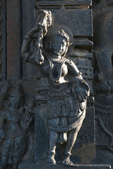 Stone Sculpture of Beautiful Female (Madanikas) with selective focus, 12th century Hindu temple, Ancient stone art and sculptures in each pillars, Chennakeshava Temple, Belur, Karnataka, India.