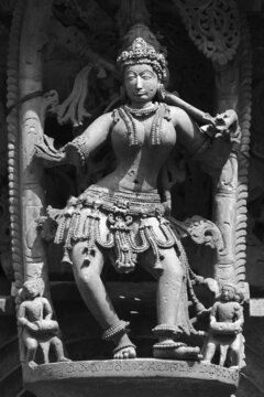 Stone Sculpture of Beautiful Female (Madanikas) with selective focus, 12th century Hindu temple, Ancient stone art and sculptures in each pillars, Chennakeshava Temple, Belur, Karnataka, India.