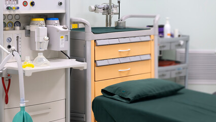 Modern operation room with operating bed and an anesthetic machine.