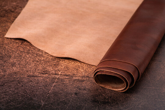Roll of natural brown leather. Material for manufacture of bags, shoes, clothing and accessories.
