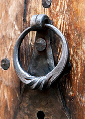 Old door knocker on a wooden door