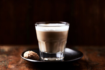 Coffee with milk on dark wooden background. Soft focus. Close up. Copy space.