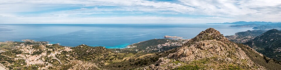 Fototapeta na wymiar Panoramic view of the coastline of Corsica and the village of Corbara, Bodri beach the red rock of Ile Rousse with Cap Corse in the distance