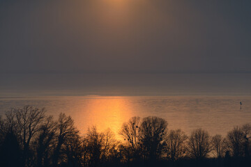 Fototapeta na wymiar Golden light on blue lake