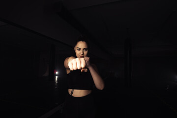 Fototapeta na wymiar Portrait of a beautiful boxer girl with white hands