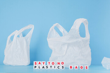 Say to no plastics bags words from cubes on the background of a white plastic bag. Plastic free concept.