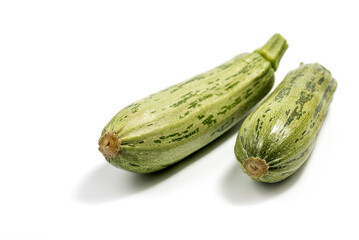 Fresh cut zucchini isolated on a white background with clipping path. Design element for product label. Design image of fresh whole zucchini. Green zucchini vegetables isolated on white.