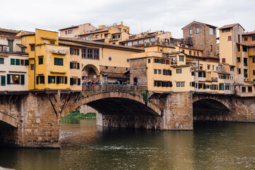 Fototapeta na wymiar Florence famous Ponte Vecchio bridge on a cloudy day, close-up. Famous Italian landmarks