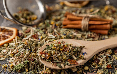 Herbal tea in a wooden spoon on a black textural cement background.Detox and immunity tea.Herbal...