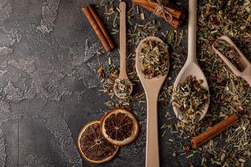 Herbal tea in a wooden spoon on a black textural cement background.Detox and immunity tea.Herbal...