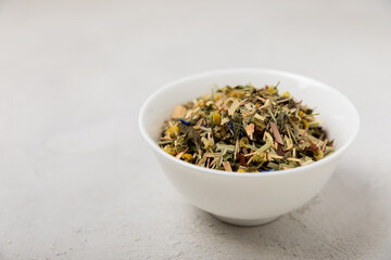 Herbal tea in a white ceramic bowl and spices on a light background. tea for immunity and detox.  space for text. Tea ceremony