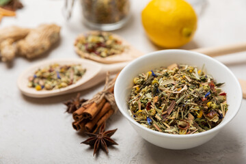 Herbal tea in a white ceramic bowl and spices on a light background. tea for immunity and detox.  space for text. Tea ceremony