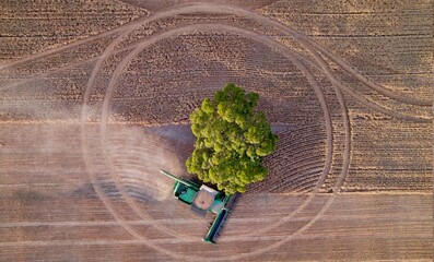 machinery harvesting in a field top down drone photo 