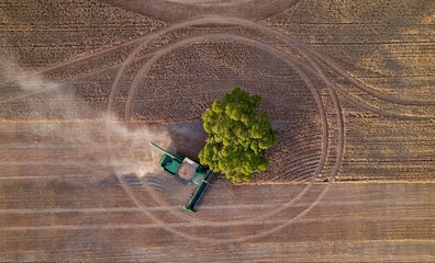 machinery harvesting in a field top down drone photo 