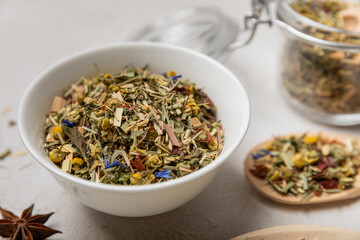 Herbal tea in a white ceramic bowl and spices on a light background. tea for immunity and detox.  space for text. Tea ceremony