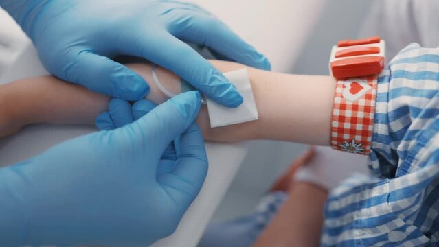 doctor or nurse takes blood from a vein in a child of a boy. Blood chemistry