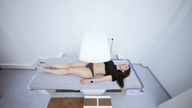 young pretty girl on examination in a modern clinic by densitometry