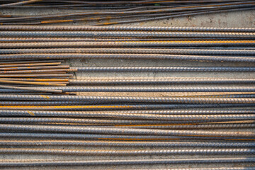 Steel rods bars, Metal, and Iron reinforcement lying on the ground on the construction site for material used for reinforcing concrete building construction.