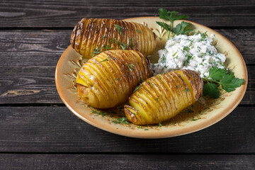 simple rustic food, baked potato with cottage cheese and herbs on a dark wooden background