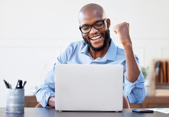 Another win for us. Shot of a businessman looking cheerful while working on his laptop in his...