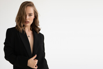 Obraz premium Natural look. Beauty model woman . Model test portrait with young beautiful fashion model posing on grey background. Blond woman in a black blazer . Natural makeup