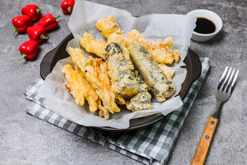 Deep-fried Laver Roll, Deep-fried Squid snack on a black plate