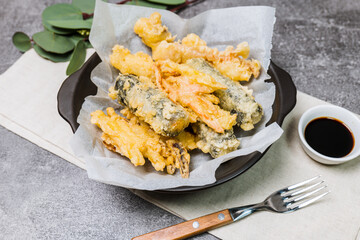Deep-fried Laver Roll, Deep-fried Squid snack on a black plate
