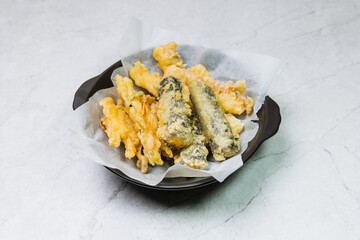 Deep-fried Laver Roll, Deep-fried Squid snack on a black plate